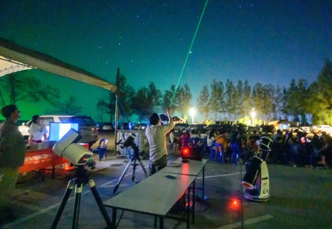 Outdoor night sky observation with telescopes and a laser-guided constellation tour.